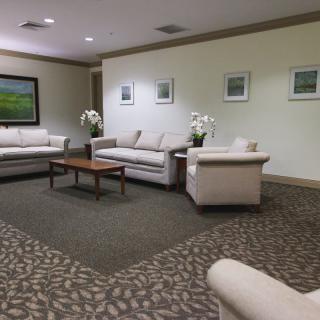 A comfortable lobby area with sofas and artwork on the walls.