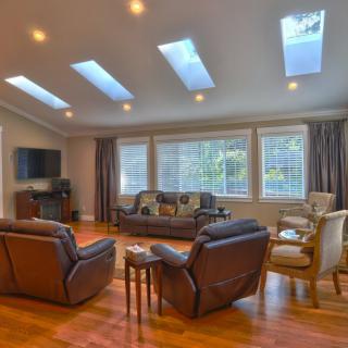 Spacious living room with elegant furniture and natural lighting.