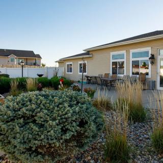 A well-maintained backyard with a patio and diverse landscaping.