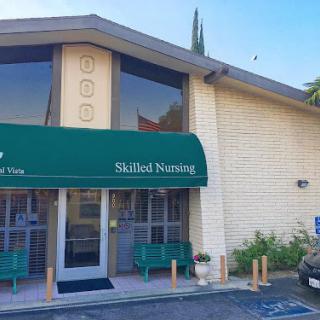 Exterior view of a skilled nursing facility with green awning.