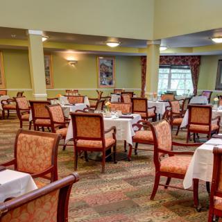 An elegant dining area with neatly arranged tables and chairs.