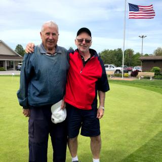 Two friends enjoying a day on the golf course.