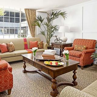 A cozy and elegantly furnished living room with comfortable seating and decorative elements.