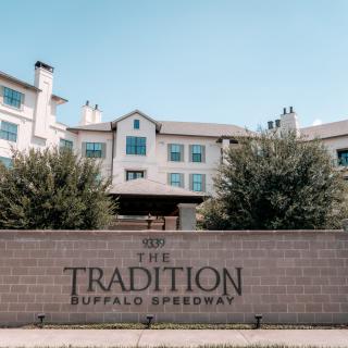 The Tradition at Buffalo Speedway building with a prominent entrance sign.