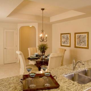 Elegant dining area with a decorated table and chandelier lighting.