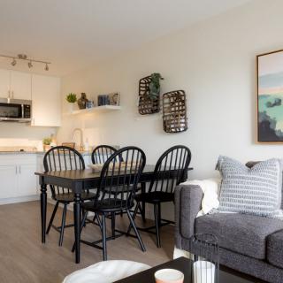 A modern open-concept living space featuring a cozy dining area and a stylish kitchen.