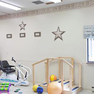 A physical therapy room with exercise equipment and therapy tools.