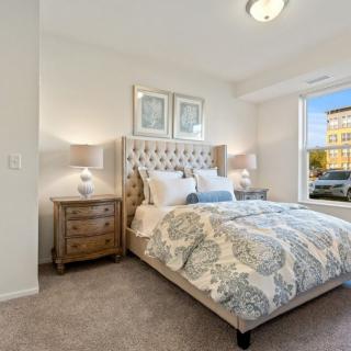 A cozy bedroom with elegant decor and a large window.