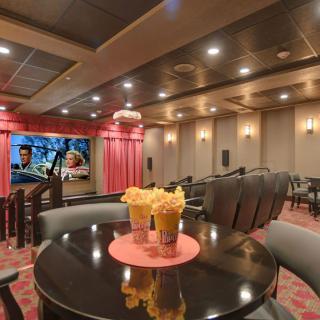 Luxurious home theater with plush seating and freshly prepared popcorn.