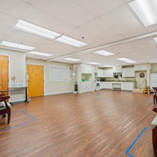 A spacious and well-lit interior kitchen area with wooden flooring.