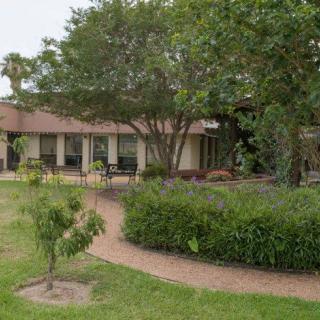 A charming house with a well-maintained garden and winding pathway.