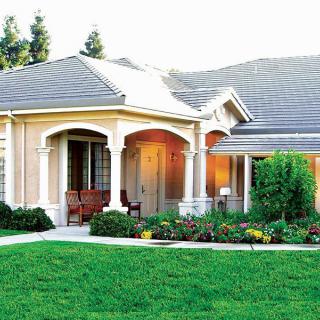 A beautiful single-story home with a well-maintained front yard and garden.