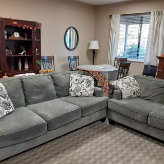 A cozy living room with a comfortable sofa set and home decor elements.
