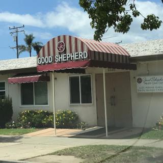 The entrance to a local establishment with a distinctive red and white striped awning.