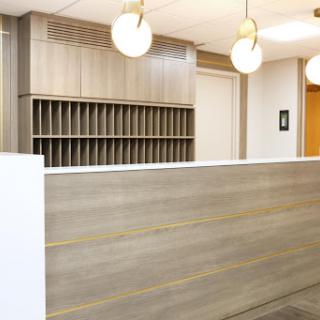 A modern office reception area featuring sleek design and ambient lighting.