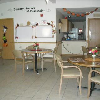 An empty, decorated dining area with tables and chairs.