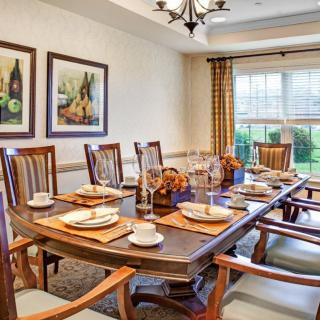 A well-decorated dining room with a set table and elegant decor.