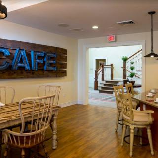 A cozy cafe interior featuring wooden furniture and modern design elements.