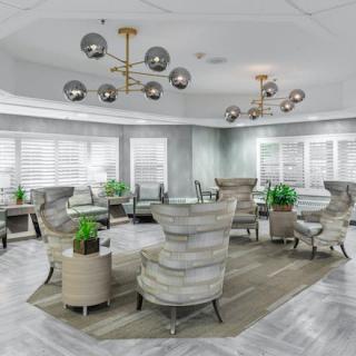 A modern lounge area with stylish seating and contemporary chandeliers.