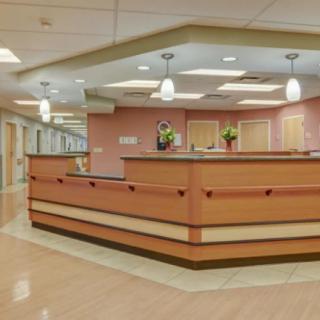 A modern reception desk in a hospital setting, featuring bright lighting and a clean, organized design.