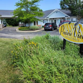 A welcoming entrance to a place named 'Pinnacle View' surrounded by greenery.
