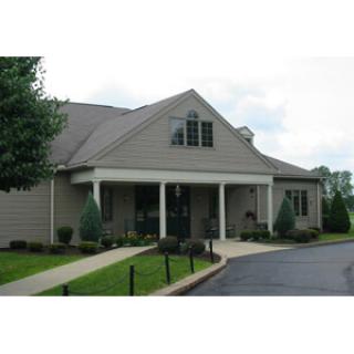 A charming residential building with well-maintained landscaping.