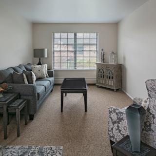 A bright and minimalist living room featuring a comfortable sofa and stylish decor.