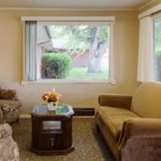 Cozy living room with a large window and comfortable seating.