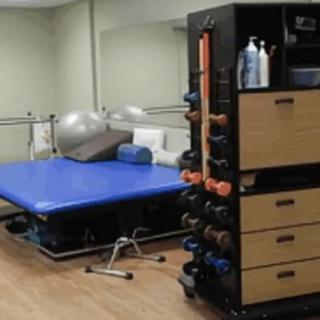 A gym area with exercise equipment, including weights and exercise balls.