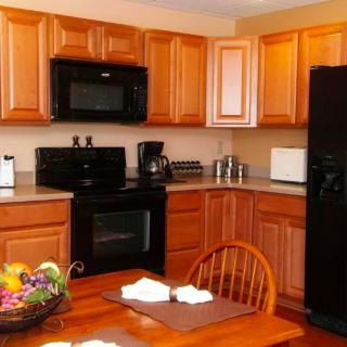 A cozy kitchen with wooden cabinets and modern appliances.