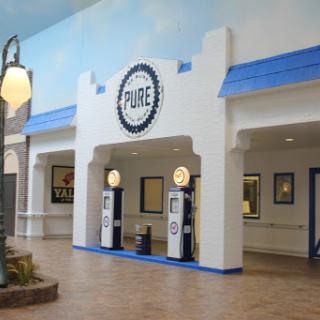 A vintage-style gas station interior with decorative pumps and a classic aesthetic.