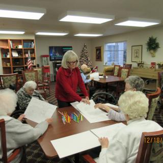 A group of seniors engaged in an art activity at a community center.