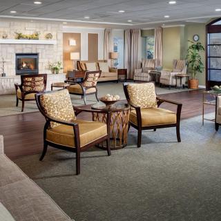 A cozy living room with comfortable chairs and a warm fireplace.