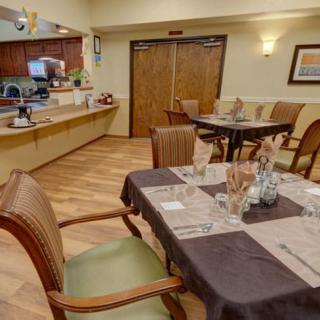 A cozy dining area with neatly set tables and chairs, ready for guests.