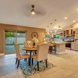 A modern open-concept kitchen and dining area with stylish decor and ample lighting.