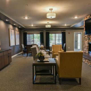 A modern living room interior with stylish furniture and ambient lighting.