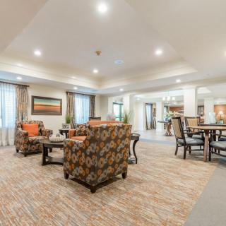 A spacious and well-lit living room with comfortable seating and elegant decor.