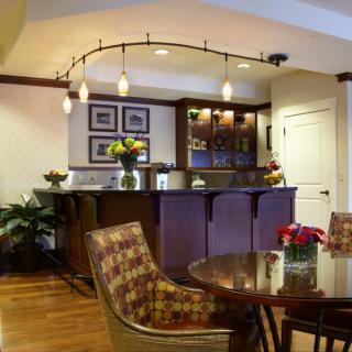 A cozy kitchen with a bar area and elegant interior design.
