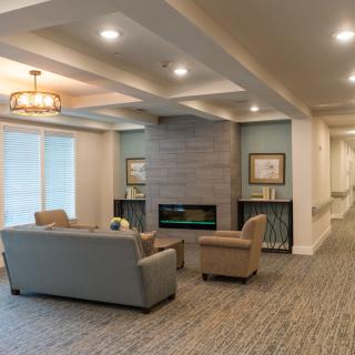A modern living room with comfortable seating and a cozy fireplace.