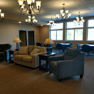 A cozy lounge with sofas and chandeliers.