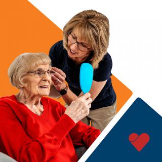 A caregiver provides personal attention and support to an elderly individual, showcasing the importance of compassion in healthcare.