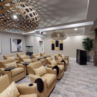 A modern lounge area with comfortable seating and unique lighting fixtures.