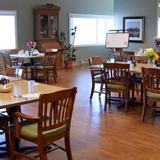 A cozy dining area with neatly arranged tables and chairs.