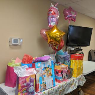 A colorful birthday party setup with gifts and festive balloons.