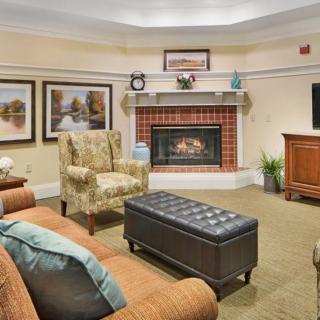 A cozy living room with a fireplace and comfortable seating.