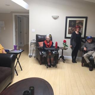 A group of people relaxing in a living room setting with comfortable seating and home decor.