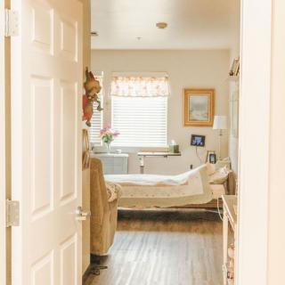 A cozy bedroom with a neatly made bed, soft lighting, and tasteful decor.