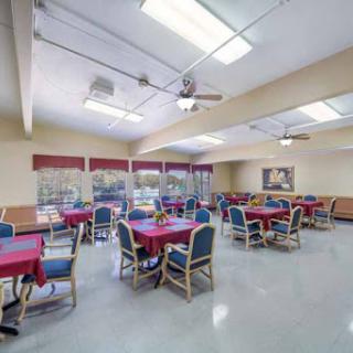 A spacious dining area with red tablecloths and ample seating.