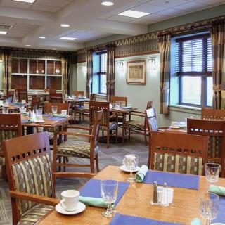 A well-arranged dining area with neatly set tables and comfortable chairs.