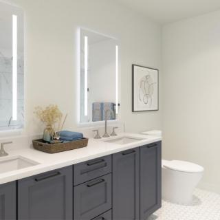 A modern bathroom featuring a double vanity with illuminated mirrors and sleek decor.